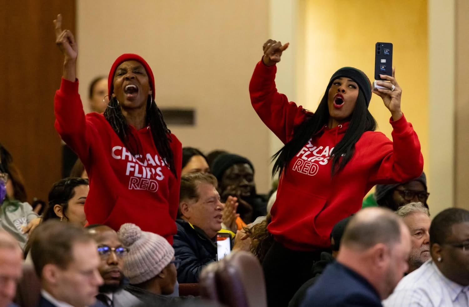 Chicago Flips Red members standing up at City Council meeting